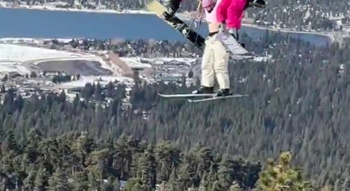 Someone hanging on to each other on ski lift