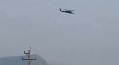 Iranian police officers shooting US air force helicopters