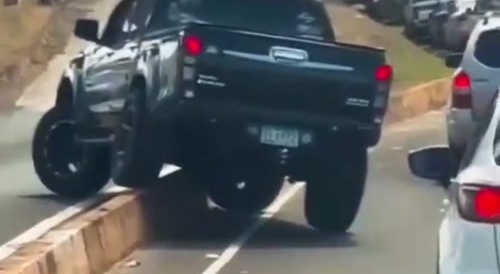 Raised pickup crosses median