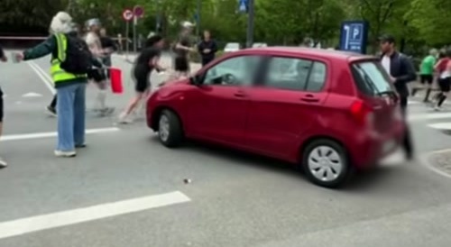 Woman drives through a marathon