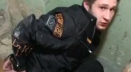 A russian tourist sits on a bottle