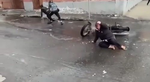 Norilsk. A woman's shoes are taken off her feet, using a motorcycle.
