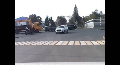 speeding biker t-bones a car at the intersection