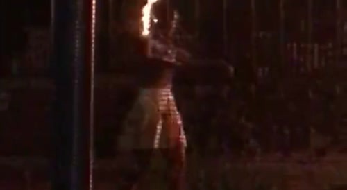 Woman With Her Head On Fire Is Wandering Around Her Wrecked Car