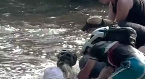 Flood Swallows Two Lady Cyclists