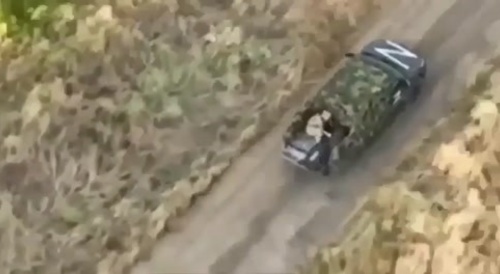 A Russian soldier disposes of his comrades' bodies to flee more quickly.