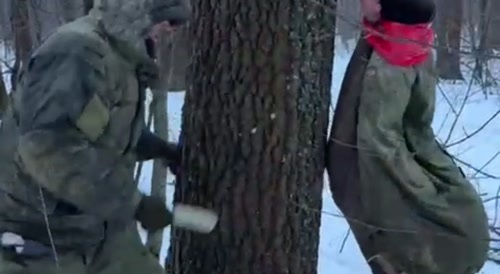 A russian commander thanks a soldier for his service using a rubber phallus.